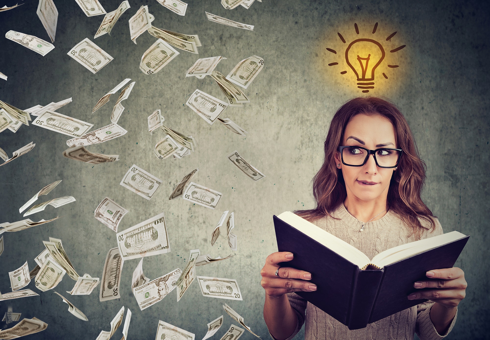 Woman student reading a book has a bright idea how to earn or save more money